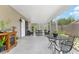 Comfortable screened patio featuring neutral walls, seating arrangements, furnishings and ample light at 8940 Se 87Th Ter, Ocala, FL 34472