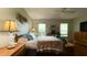 Bright bedroom featuring a comfortable bed, side tables, and large windows overlooking the neighborhood at 9490 Sw 94Th Ct, Ocala, FL 34481