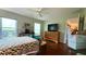 Comfortable bedroom featuring large windows, ceiling fan, and views of another room in the home at 9490 Sw 94Th Ct, Ocala, FL 34481