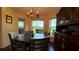 Cozy dining area with chandelier lighting, hardwood floors, and great natural light at 9490 Sw 94Th Ct, Ocala, FL 34481