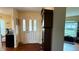 Welcoming foyer with hardwood floors and a decorative front door with sidelights at 9490 Sw 94Th Ct, Ocala, FL 34481
