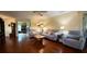 Spacious living room boasts hardwood floors, comfortable seating, and ample natural light at 9490 Sw 94Th Ct, Ocala, FL 34481