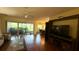 Bright and spacious living room features large windows and access to a screened lanai at 9490 Sw 94Th Ct, Ocala, FL 34481