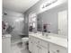 Bathroom featuring a glass-enclosed shower, updated vanity with white marble top, and tiled flooring at 9587 Sw 84Th Ter # E, Ocala, FL 34481