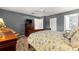 Comfortable bedroom featuring a ceiling fan, tiled floors, and a TV at 9587 Sw 84Th Ter # E, Ocala, FL 34481
