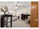 Bedroom featuring a bed, two windows with shutters, dark wood furniture and a ceiling fan at 9587 Sw 84Th Ter # E, Ocala, FL 34481