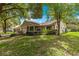 Beautiful single-story home featuring a well-maintained lawn and mature trees at 9587 Sw 84Th Ter # E, Ocala, FL 34481