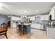The kitchen features an island with seating, white cabinets, and stainless steel appliances at 9587 Sw 84Th Ter # E, Ocala, FL 34481