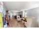 Spacious living room showcasing tile flooring, neutral paint and furnishings, and access to the dining room at 9587 Sw 84Th Ter # E, Ocala, FL 34481