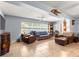 Inviting living room with tile floors, large windows, and comfortable seating arrangement at 9587 Sw 84Th Ter # E, Ocala, FL 34481