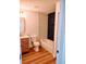 Bathroom featuring wood-look floors, a sink vanity, toilet, and a shower and tub with black brick tiling at 9721 Bahia Rd, Ocala, FL 34472