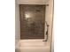 Close-up of a shower featuring dark, brick tiling, a handheld shower head, and a standard shower head at 9721 Bahia Rd, Ocala, FL 34472