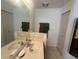 Bathroom featuring double sinks, a large mirror, and tile flooring at 9730 Sw 90Th St, Ocala, FL 34481