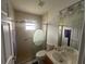 Cozy bathroom with a clear glass door shower, neutral finishes, and tiled flooring at 9730 Sw 90Th St, Ocala, FL 34481
