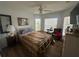 Bright bedroom featuring wood floors, a ceiling fan, and plenty of natural light streaming through the windows at 9730 Sw 90Th St, Ocala, FL 34481