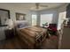 Comfortable bedroom featuring wood floors, windows with blinds, and ample natural light at 9730 Sw 90Th St, Ocala, FL 34481