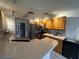 Well-lit kitchen featuring wood cabinets, stainless steel appliances, and an island with stone countertops at 9730 Sw 90Th St, Ocala, FL 34481