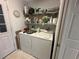 Functional laundry room equipped with a washer, dryer, and plenty of storage shelving at 9730 Sw 90Th St, Ocala, FL 34481