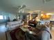 Spacious living room with hardwood floors, sofas and a view into the kitchen at 9730 Sw 90Th St, Ocala, FL 34481