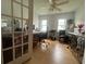Bright office space with french doors, wood floors, ceiling fan, and dual desks at 9730 Sw 90Th St, Ocala, FL 34481