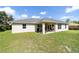 The home's rear exterior features an open patio area and a spacious backyard at 9957 Sw 45Th Ave, Ocala, FL 34476