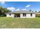 Back exterior view featuring a covered patio, an open backyard, and a peaceful setting at 9957 Sw 45Th Ave, Ocala, FL 34476