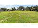 Expansive backyard with lush green grass, mature trees, and a white fence on the perimeter at 9957 Sw 45Th Ave, Ocala, FL 34476