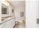 Bright bathroom features a granite vanity, tile flooring, and a tiled shower visible in the mirror's reflection at 9957 Sw 45Th Ave, Ocala, FL 34476