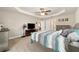 Large bedroom features a trey ceiling, ceiling fan, neutral paint, carpet, and ensuite access at 9957 Sw 45Th Ave, Ocala, FL 34476