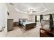 Bedroom boasts a trey ceiling, ceiling fan, neutral tones, carpet, and large window for ample natural light at 9957 Sw 45Th Ave, Ocala, FL 34476