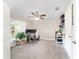 Comfortable bedroom with a ceiling fan, carpet floors, and a bright window view at 9957 Sw 45Th Ave, Ocala, FL 34476