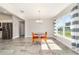 Dining area with modern lighting and large windows providing ample natural light throughout the space at 9957 Sw 45Th Ave, Ocala, FL 34476