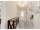 A bright foyer with decorative chandelier, wood floors and a decorative console table at 9957 Sw 45Th Ave, Ocala, FL 34476