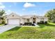 Charming single-story home with a well-manicured lawn and inviting curb appeal during daylight at 9957 Sw 45Th Ave, Ocala, FL 34476