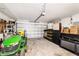 Spacious garage provides ample storage with shelving, lawnmower and workbench at 9957 Sw 45Th Ave, Ocala, FL 34476