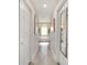 Hallway view to soaking tub and dual vanity bathroom with tile floors, offering a luxurious retreat at 9957 Sw 45Th Ave, Ocala, FL 34476