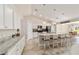 Elegant kitchen featuring white cabinetry, granite countertops, stainless steel appliances and kitchen island seating at 9957 Sw 45Th Ave, Ocala, FL 34476