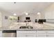 Open kitchen layout with granite counters and stainless appliances, offering a view of the living room at 9957 Sw 45Th Ave, Ocala, FL 34476