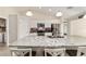 Bright kitchen features white cabinets, stainless steel appliances, and a large granite-topped island with seating at 9957 Sw 45Th Ave, Ocala, FL 34476