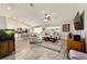 Inviting living room with neutral tones, a large sectional sofa, and seamless flow to the kitchen at 9957 Sw 45Th Ave, Ocala, FL 34476