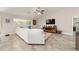 Relaxing living area featuring a sectional sofa, large window, and stylish decor for modern living and relaxation at 9957 Sw 45Th Ave, Ocala, FL 34476