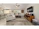 Cozy living room features an L-shaped sofa, decorative rug, and entertainment center beneath a wall-mounted TV at 9957 Sw 45Th Ave, Ocala, FL 34476