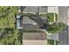 Aerial view of a home featuring solar panels, landscaped yards, and neighborhood surroundings at 125 Placid Woods Ct, Sanford, FL 32773