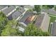 Aerial view of a home with solar panels, a well-maintained yard, and neighborhood surroundings at 125 Placid Woods Ct, Sanford, FL 32773