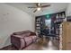 Cozy bedroom with dark wood floors, a comfortable sofa, gaming setup, and ample shelf space at 125 Placid Woods Ct, Sanford, FL 32773