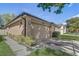 Tan home with a two-car garage featuring an address number and lush landscaping at 125 Placid Woods Ct, Sanford, FL 32773