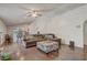 Cozy living room with hardwood floors, a ceiling fan, and open view to the kitchen at 125 Placid Woods Ct, Sanford, FL 32773