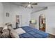 Bedroom featuring hardwood floors, ceiling fan, and ensuite bathroom at 125 Placid Woods Ct, Sanford, FL 32773