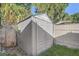 Durable outdoor shed surrounded by a wooden fence, offering practical backyard storage solutions at 125 Placid Woods Ct, Sanford, FL 32773
