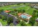 Community aerial view featuring a clubhouse, pool, and parking area at 1266 James Island St, The Villages, FL 32162